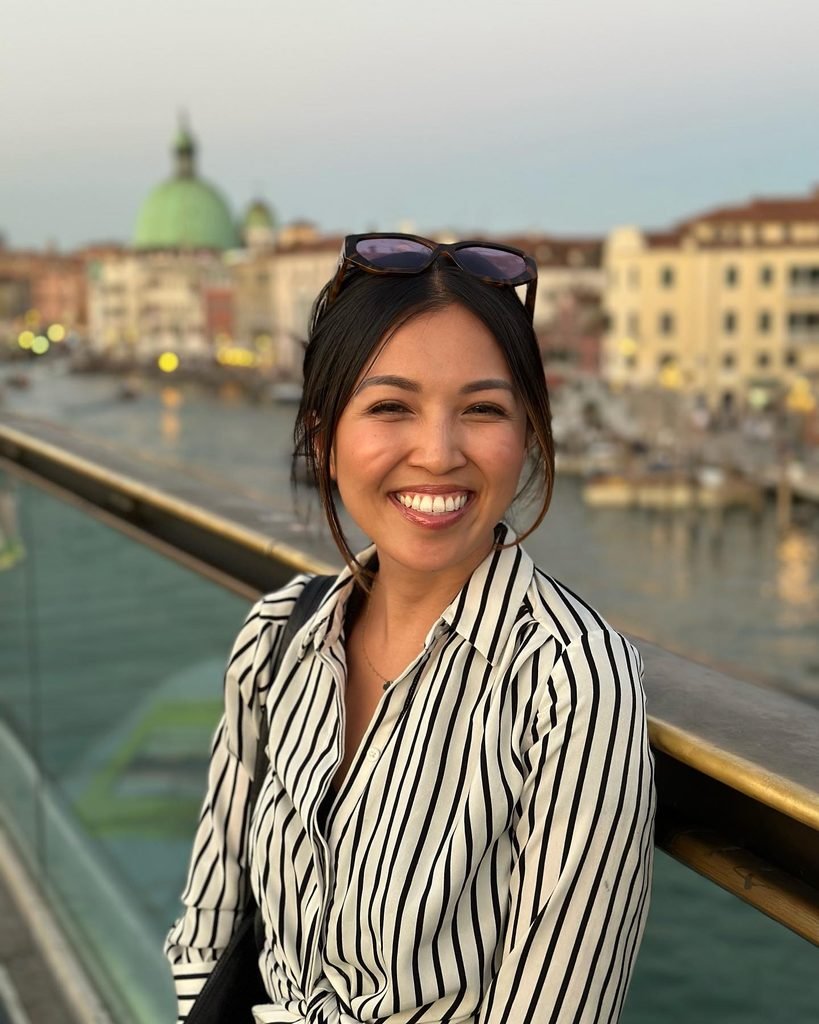 Thao Chau smiling outdoors while traveling.